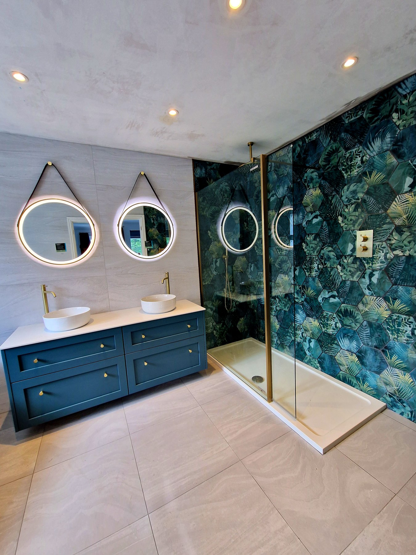 Teal botanical feature wall with dual basins and brass fittings