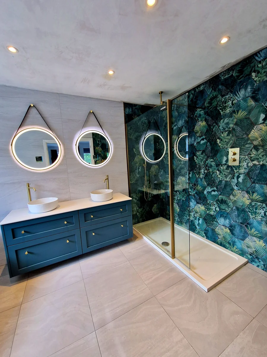 Teal botanical feature wall with dual basins and brass fittings