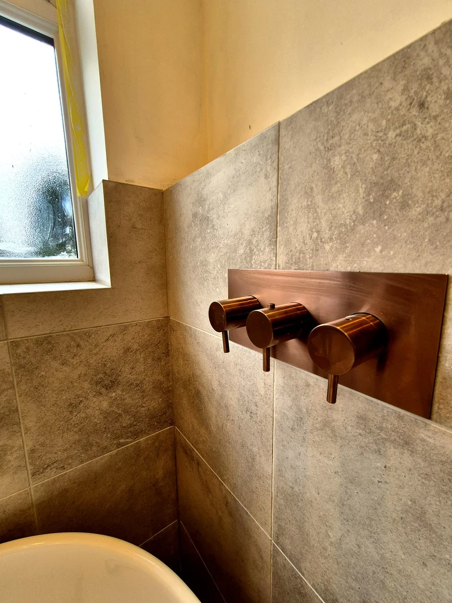 Brushed copper wall-mounted shower valves
